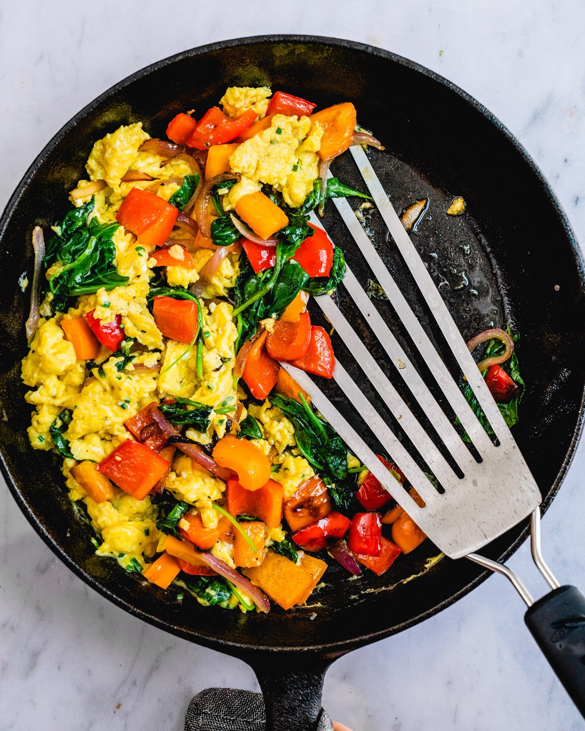 Healthy breakfast scramble with veggies in a skillet.