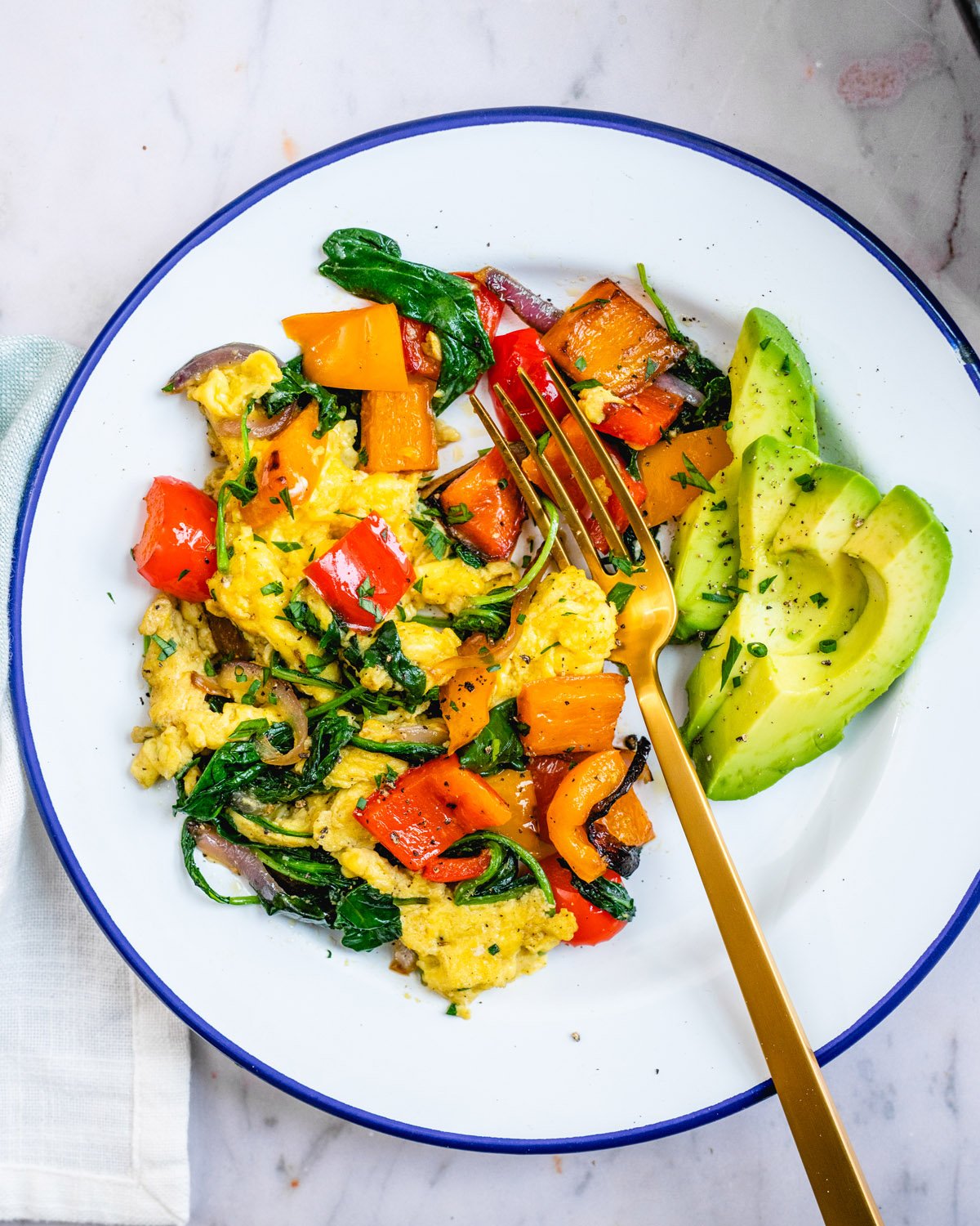 Easy breakfast ideas: veggie scramble on a plate with fork.