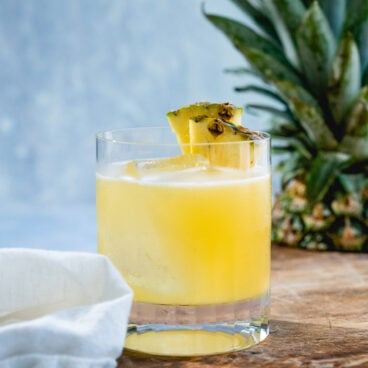 Pineapple Margarita in rocks glass with pineapple garnish.